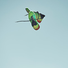 Image showing Soccer, shoes and freedom fitness, health and sport workout sportswear in blue studio background. Football boots, colourful and worn-out cardio sneakers in air levitation from athlete success match