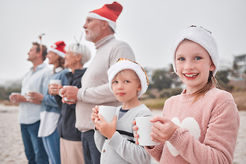 Image showing Family, generations and Christmas, drink and view outdoor while on vacation, holiday and festive time at the beach. Parents, grandparents and children, happy with hot chocolate, mug and xmas hat.