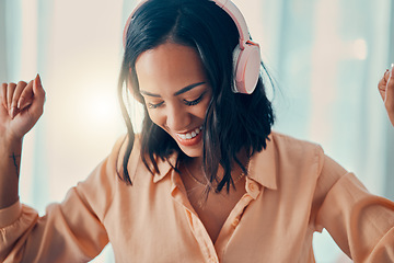 Image showing Music, dance and freedom with a woman listening to audio on headphones in her home alone. Radio, dancing and fun with an attractive young female streaming an online subscription service in her house