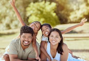 Image showing Happy family, portrait and relax in a park in summer, happy and playing, smile and bonding while lying in grass together. Family, rest and kids enjoy quality time with parents, excited and cheerful