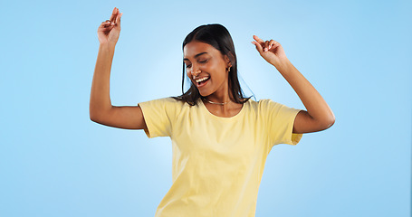 Image showing Dance, woman and studio with freedom, smile and happy with modern fashion and fun in studio. Blue background, female person model and music with dancer and celebration with confidence and excited