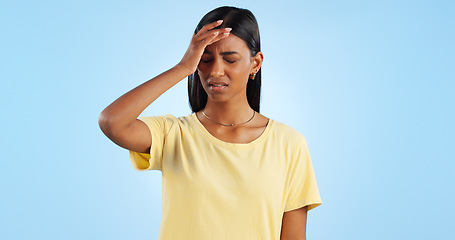 Image showing Headache, pain and stress, woman with fatigue in studio with health emergency and wellness on blue background. Migraine, brain fog and vertigo from medical condition with burnout, sick and tired