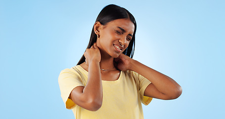 Image showing Neck pain, health and woman in studio with spine issue, emergency and bad posture on blue background. Muscle, pressure and fibromyalgia, sick with burnout and injury, mockup space and inflammation