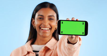 Image showing Phone green screen, studio portrait and happy woman show online presentation, social media info or commercial news. Tracking markers, smartphone chroma key and mockup space person on blue background