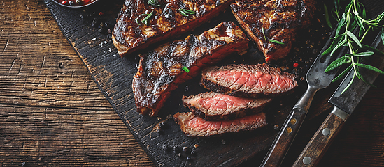 Image showing Grilled top sirloin or cup rump beef meat steak on wooden board