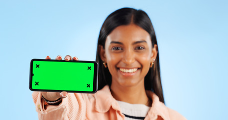 Image showing Smartphone green screen, studio portrait and happy woman show internet connection, mobile promotion or app chroma key. Tracking markers, cellphone mockup space and tech person face on blue background