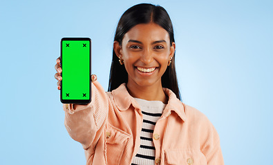 Image showing Smartphone green screen, happy portrait and woman show web communication, mobile search engine or app chroma key. Tracking markers, cellphone mockup space and studio tech person on blue background