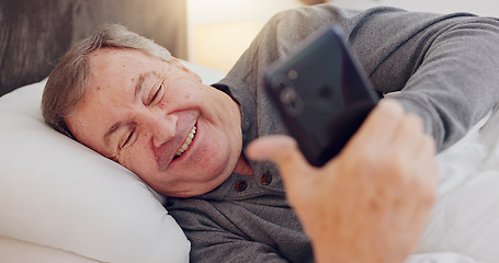 Image showing Senior man, happy and reading with phone in bed or streaming funny, comedy or meme on social media. Elderly person, smile or relax with cellphone at night in bedroom with communication or online chat