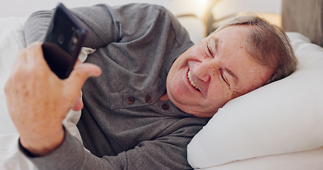 Image showing Happy, senior man and reading with phone in bedroom or streaming funny, comedy or meme on social media. Elderly person, smile or relax with cellphone at night in bed with communication or online chat