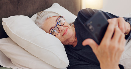 Image showing Cellphone, relax and senior woman in bed networking on social media, mobile app or internet. Technology, rest and elderly female person in retirement scroll on website with phone in bedroom at home.