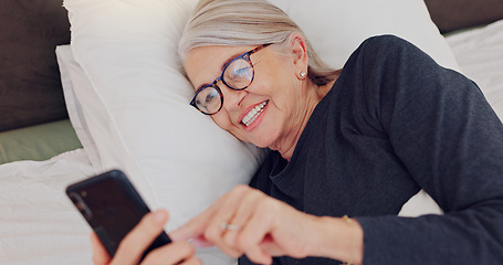 Image showing Happy, senior woman and reading with phone in bed or streaming funny, comedy or meme on social media. Elderly person, smile or relax with cellphone at night in bedroom with communication or chat