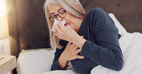 Image showing Sick, blowing nose and senior woman in bed with allergies, flu or cold on weekend morning at home. Illness, sneezing and elderly female person in retirement with tissue for sinus in bedroom at house.