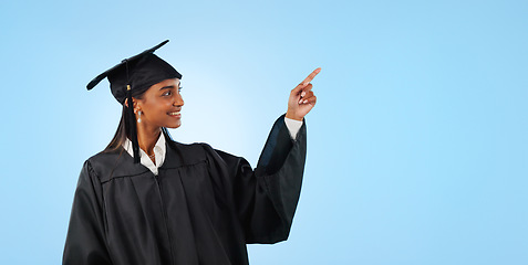 Image showing Graduate student, studio and happy woman point at school direction, university commercial or college knowledge development. Mockup space, graduation and higher education choice on blue background