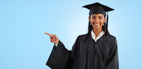 Image showing Graduate, studio portrait or happy woman point at school registration, university ads or college information, choice or academy. Mockup space, education and graduation notification on blue background