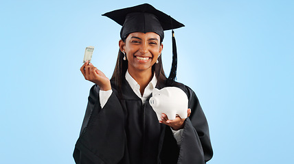 Image showing Woman, graduation and piggy bank in studio, money or saving for investing, future or portrait by blue background. Student girl, banking and cash for education, decision or choice for financial plan