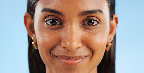 Image showing Face, smile and woman with beauty and skin glow, wellness with positive attitude and natural on blue background. Skincare, dermatology and happy in portrait, closeup of facial with shine in studio