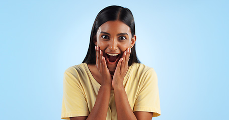 Image showing Excited, woman and crazy portrait with wow, surprise and winner with a smile in a studio. Blue background, happy and celebration with female person shocked from omg announcement and achievement