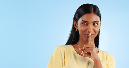 Image showing Secret, gossip and woman with finger on lips, smile and announcement on a blue background. Person, girl and model with privacy, mockup space and drama news with surprise, emoji and whisper with shush