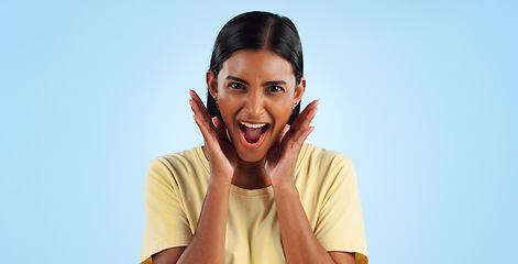 Image showing Wow, portrait and woman or excited for surprise, winner or announcement in studio with mock up space. Indian, face or person with surprised expression for discount, sale or success on blue background