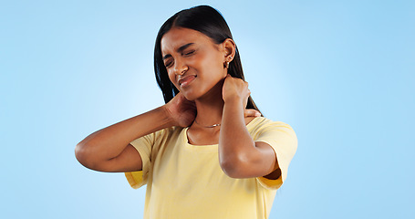 Image showing Neck pain, healthcare and woman in studio with spine issue, emergency and bad posture on blue background. Muscle pressure, fibromyalgia and sick with burnout and injury, mockup space and inflammation