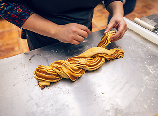 Image showing Female hands preparing a salted caramel babka.