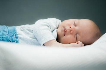 Image showing Close-up portrait of adorable baby boy sleeping in bed, 1 year old baby concept