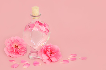 Image showing Rose Flower Perfume in Heart Shaped Bottle with Pink Roses 