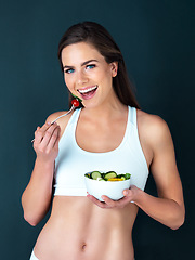 Image showing Salad, woman eating and portrait with fitness, health and nutrition of meal with smile in studio. Workout, happy and female model with exercise and training with healthy food and vegetables for diet