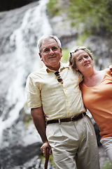 Image showing Senior, man and woman with portrait by waterfall for travel, sightseeing or holiday with happiness. Elderly, couple and face with smile for cascade, vacation and adventure on retirement or tourism