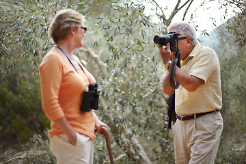 Image showing Senior, couple and camera in forest for picture, memory or photography on adventure and travel experience. Elderly, man and woman with photograph in woods for love, retirement and happiness in nature
