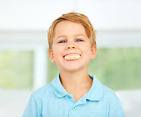 Image showing Child, portrait or orange fruit in mouth health wellness snack, happy vitality or raw food youth development. Boy, face or fresh diet smile or organic citrus nutrition, fibre breakfast or minerals