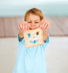 Image showing Child, playful or face food or bread funny, nutrition hungry or eating health value. Boy, diet or brown fibre for kid vitality cooking or meal prep humor for snack, lunch or dinner for comedy.