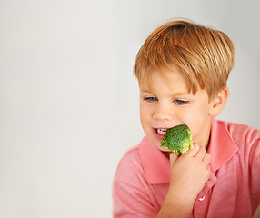 Image showing Child, broccoli and vegetables eating for healthy nutrition meal, hunger or mockup. Male person, hand and white background or fibre diet vegetarian lunch food vitamins, eco greens or dinner vitality