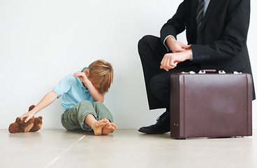 Image showing Man, work and home by child with crying, autism and businessman late to care or stop fear, support or anxiety. Father, kid or mental health on floor to help son, tired and professional papa in stress