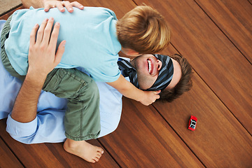 Image showing Man, blindfold and playing with child in living room, happy and family home with support of businessman with kid. Man, boy and quality time together with trust in fantasy, game and care on floor