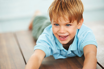 Image showing Child, happy and playing game on floor in family home, security and learning with playing, growth and development. Boy, happiness and smile in living room for fun, care and excited in kindergarten