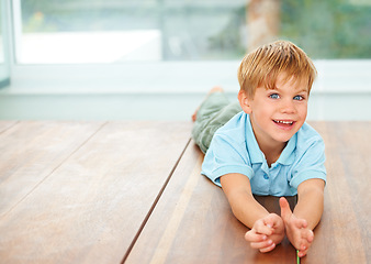 Image showing Happy, portrait and young child on floor in family home, wellness and playing games in lounge. Boy, face and smile in living room for fun, care and excited english kid, growth and toddler development