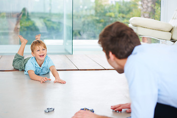 Image showing Father, child and playing on floor with toys, family home and happy with support of businessman. Man, boy or together to relax with smile, fantasy game and learning trust papa for love of cars