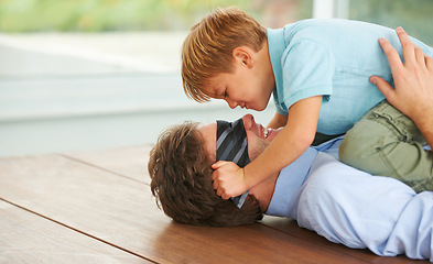 Image showing Man, blindfold and game to play with child, living room floor or happy together by support of businessman. Papa, boy and smile in family home, fantasy and love with hug, care and tie on face