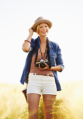 Image showing Nature, photography and woman with a camera, smile and journey with adventure, travel and memory with sunshine. Happy person, countryside or summer with photographer, outdoor and freedom with picture
