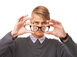 Image showing Glasses, vision and portrait of man in a studio with confused, doubt or squinting facial expression. Optometry, health and young male person with spectacles or eyewear isolated by white background.