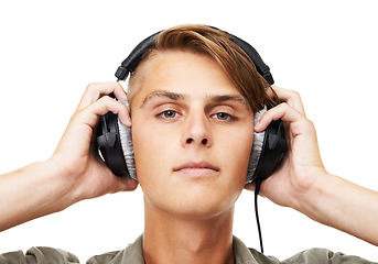 Image showing Man, face and portrait with headphones listening to music in audio streaming against a studio background. Closeup of male person, DJ or model with headset for podcast, beats or sound track on mockup