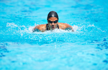 Image showing Breathe, swimming and pool with a sports woman for training, cardio workout or exercise for fitness. Athlete person or professional swimmer in blue water for speed, competition or goggles and cap