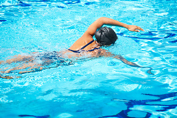 Image showing Stroke, swimming and pool with a sports woman for training, cardio workout or exercise for fitness. Female athlete person or professional swimmer in clear blue water for competition in swimsuit