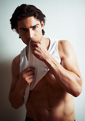 Image showing Sexy, portrait of young man in a studio with underwear for strong, body building and hot muscles. Serious, attractive and handsome male model posing in a stylish vest isolated by white background.