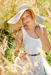 Image showing Summer, hat and smile with woman in field for travel, vacation and holiday. Relax, peace and nature with female person and grass in countryside meadow for calm environment, spring and sunshine