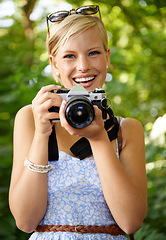 Image showing Portrait, camera lens and photographer with woman in forest for smile, memory and photography. Summer, happy and adventure with person and shooting for vacation, holiday and environmental tourism