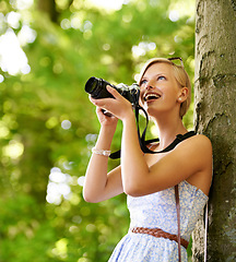 Image showing Happy, woman and photography in nature with trees, camera and vacation in environment. Forest, park and girl filming with natural happiness outdoor on summer holiday, trip or travel with technology