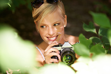 Image showing Smile, photographer and nature with woman in forest for trees, environment and relax. Shooting, camera lens and photography with face of female person in woods for travel, torusim and summer
