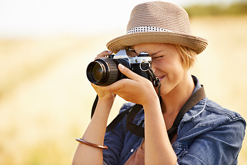 Image showing Woman, camera and photography with travel, vacation and holiday with wheat field and plants. Nature, photographer and outdoor with traveler blog and countryside with photo for adventure and journey